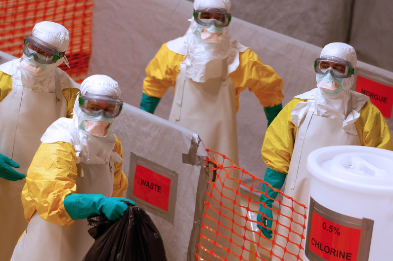 Medical workers wearing protective suits take part in a training prior to leave to countries affected by the Ebolas virus, in an empty factory warehouse in Amsterdam, on November 5, 2014 where medicals aid group Medecins Sans Frontieres (MSF) created a mock clinic. The disease has killed nearly 5,000 people, almost all of them in Sierra Leone, Liberia and Guinea. AFP PHOTO/ANP/BAS CZERWINSKI-netherlands out-
